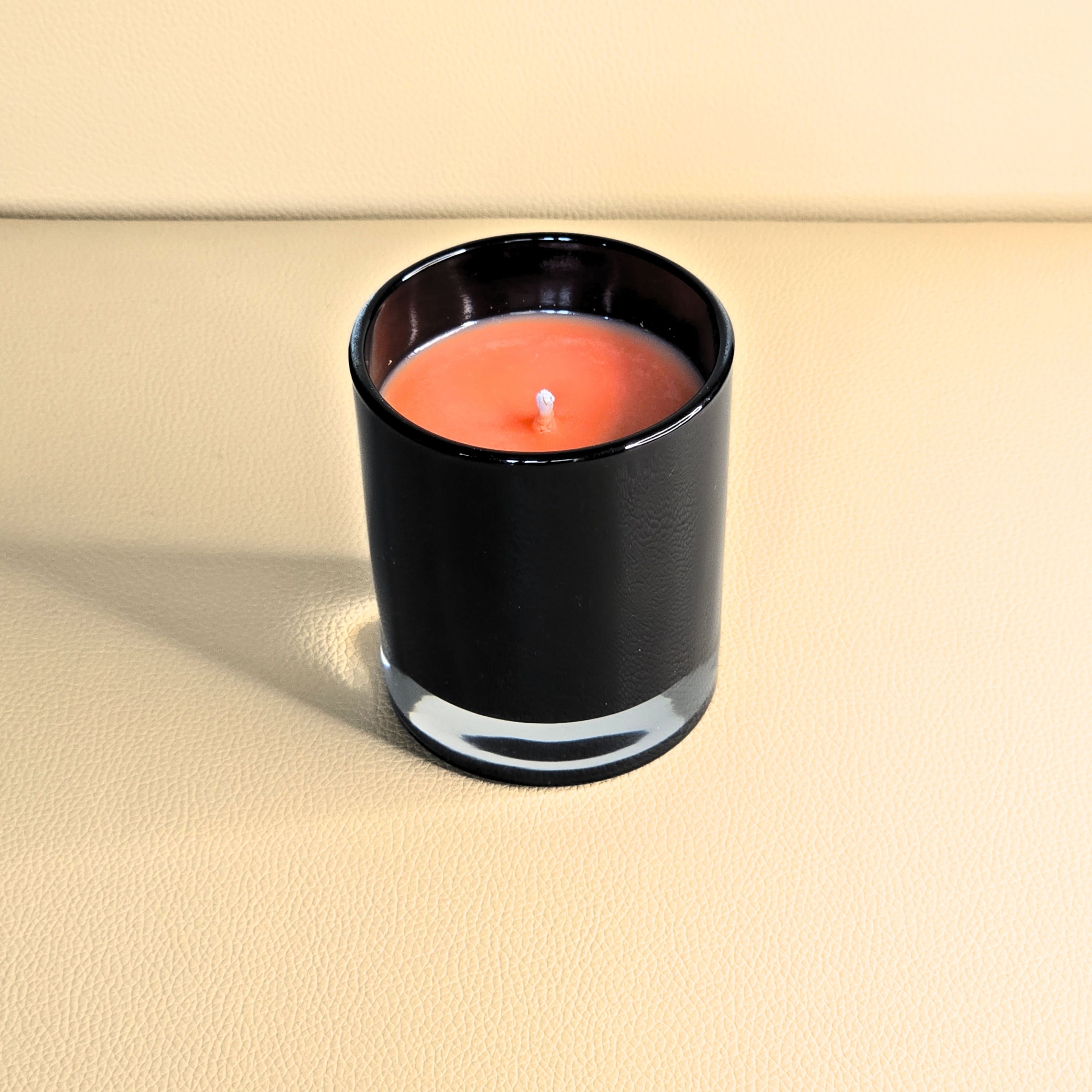 Hand-poured soy candle in black glass, amber tone wax – Wicks of Intention.