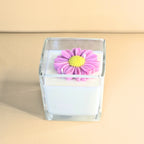 Front view of floral candle symbolising joy and self-love.