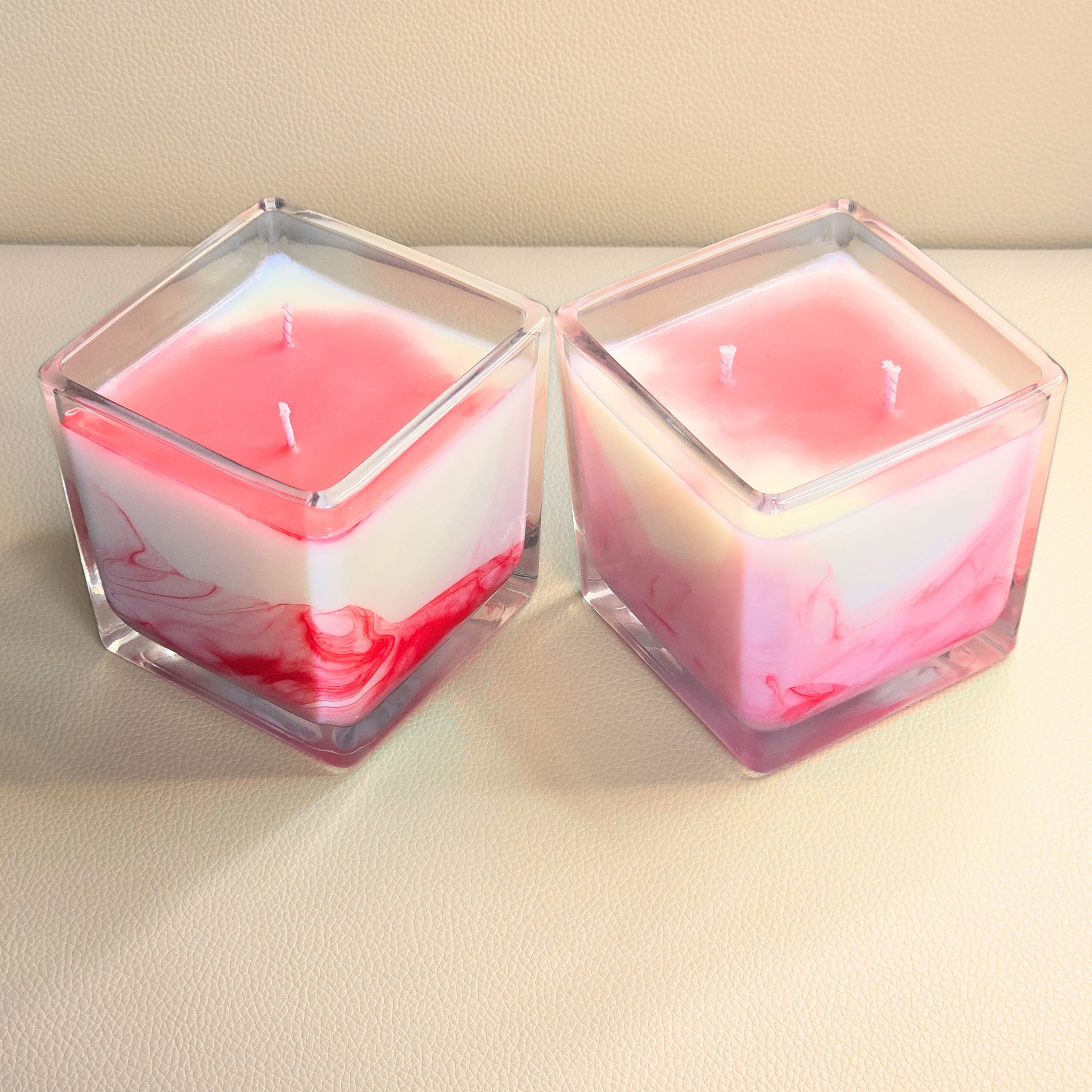 Two Passion Storm candles displaying different natural swirl variations