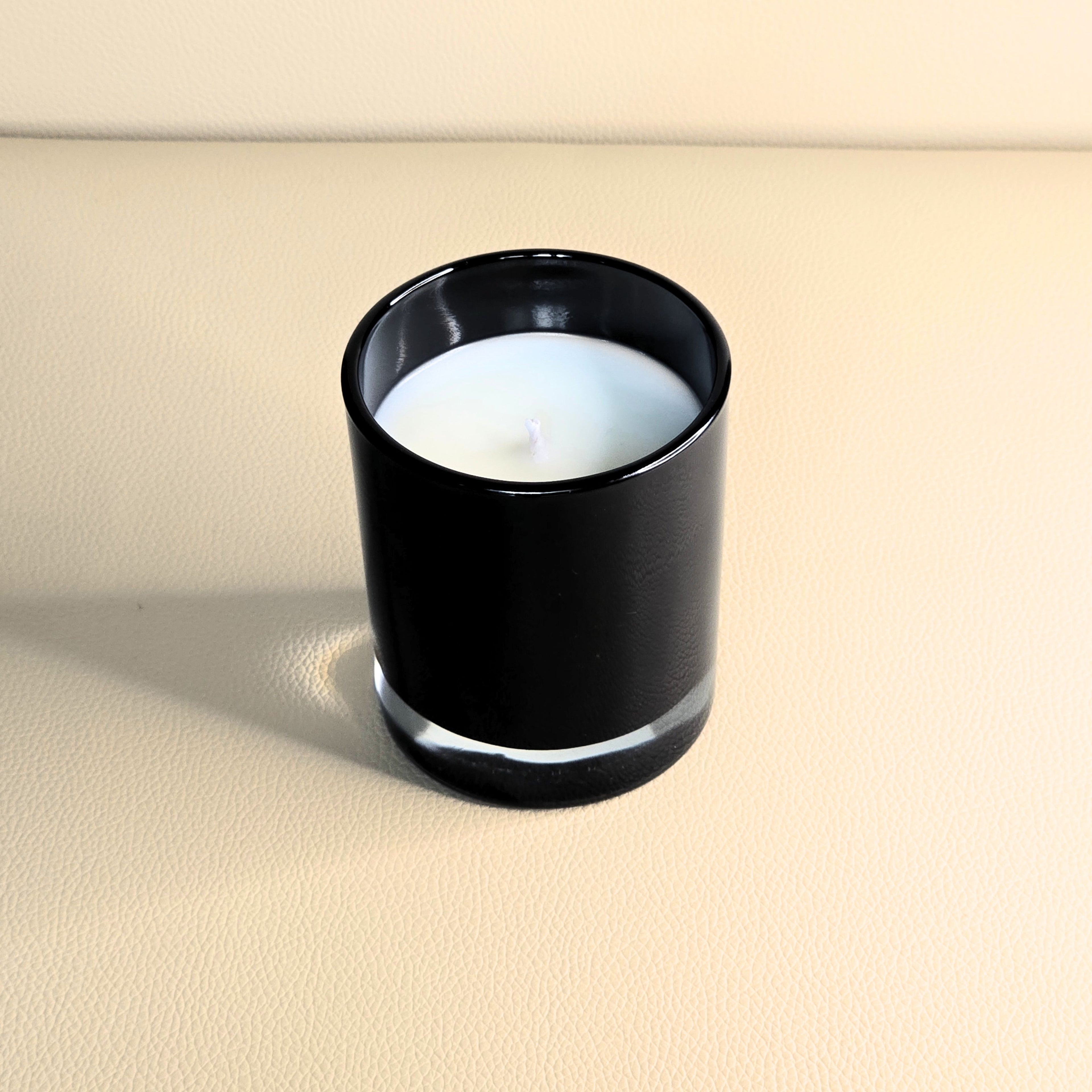 Minimalist white soy candle in glossy black glass – Wicks of Intention.